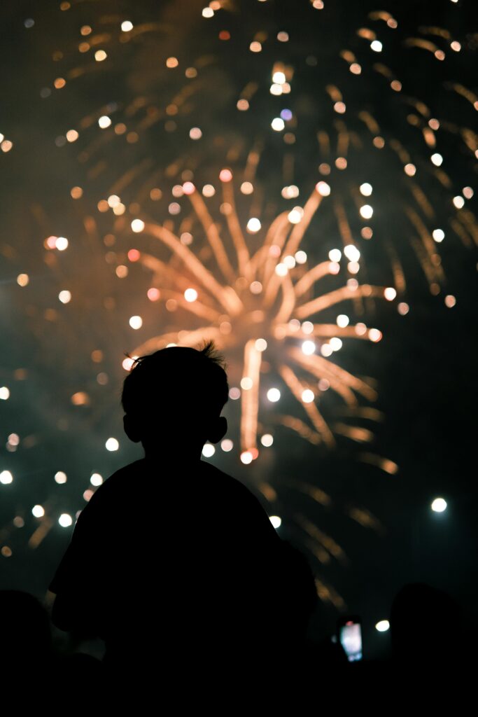 Silhouette of Child Watching Fireworks Display